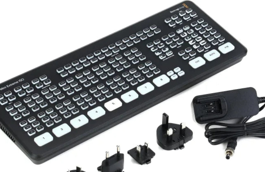 Keyboard with power adapter and plugs on a white background