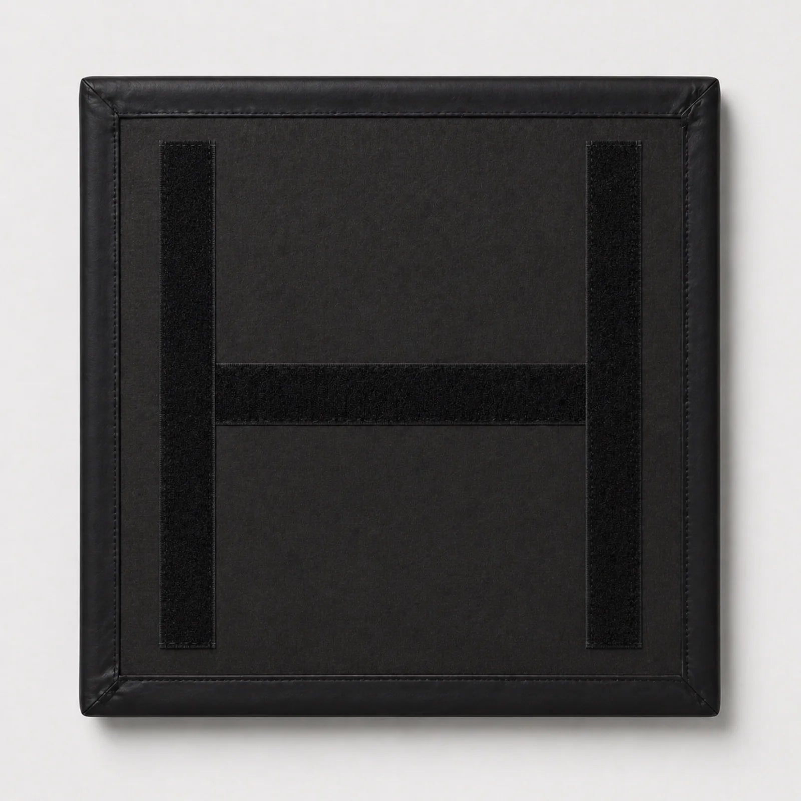 A square black padded patch with a stitched border and a large embroidered letter H in the center, shown on a light gray background.