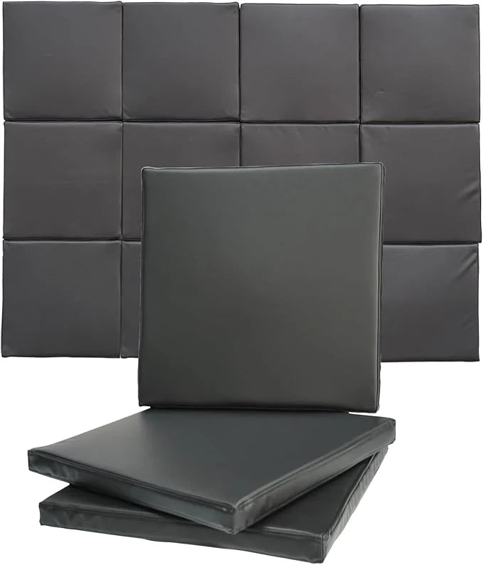 Gray foam pads stacked against a gray wall.